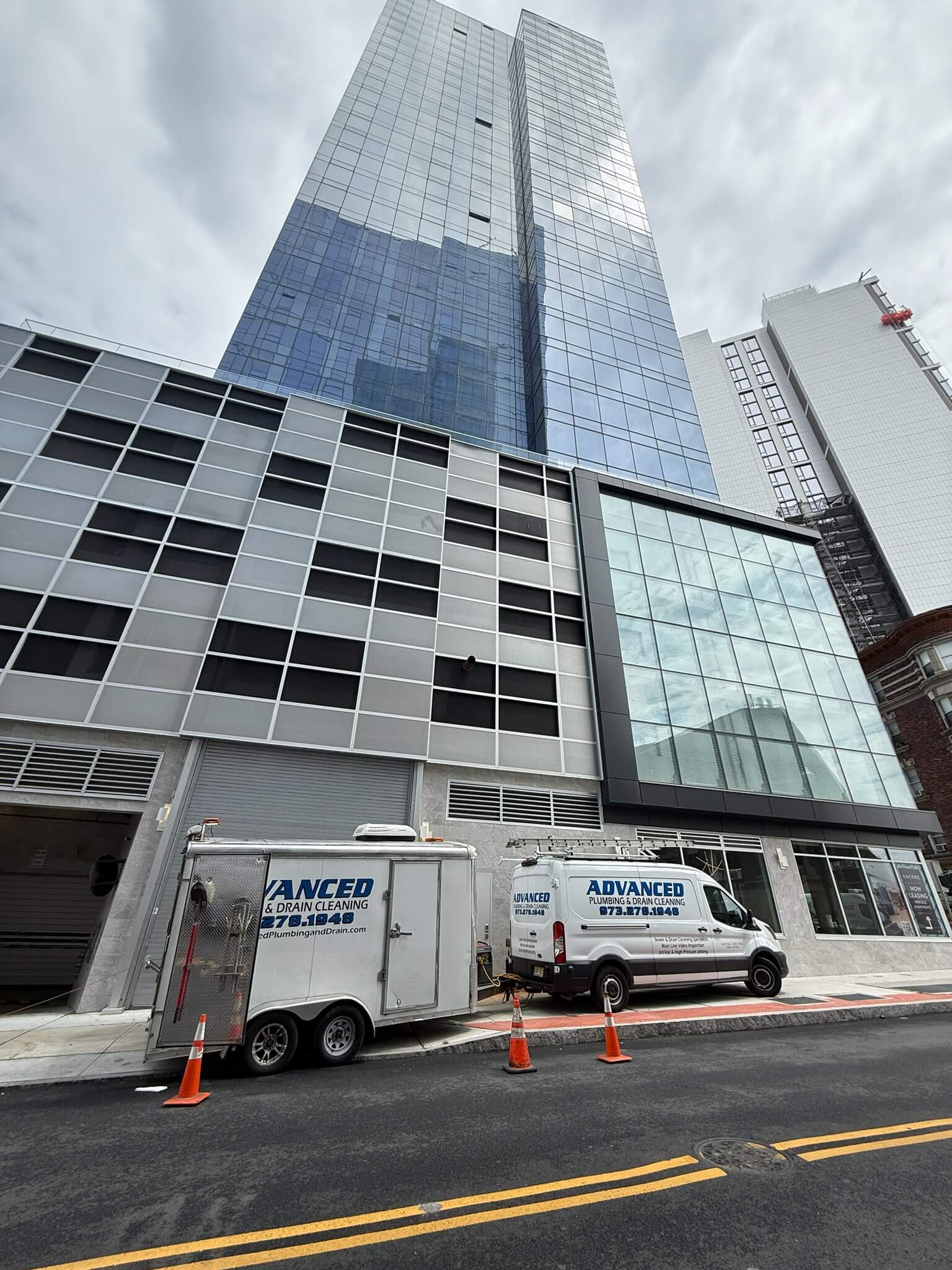 White van and a trailer, both of Advanced Plumbing & Drain Cleaning